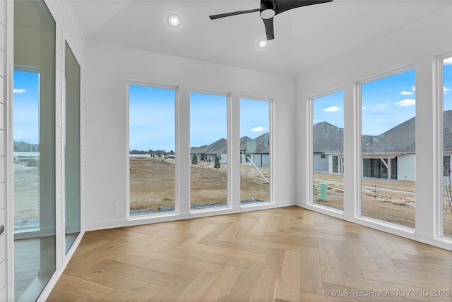 unfurnished sunroom with ceiling fan