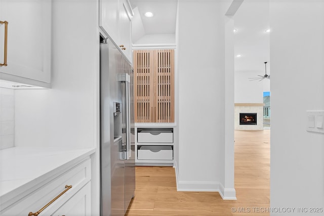 bathroom with ceiling fan, hardwood / wood-style floors, and vanity