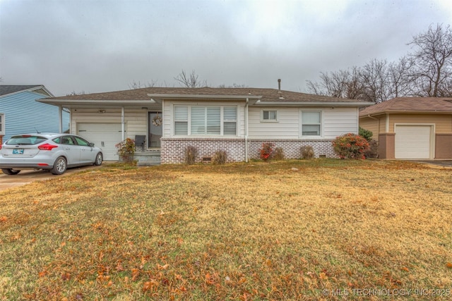 ranch-style house with a front yard and a garage