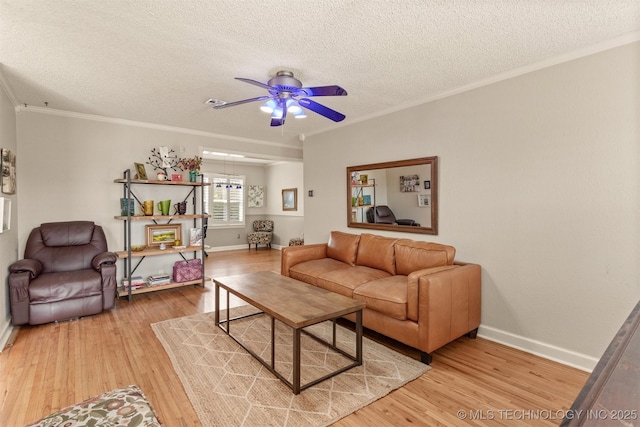 living room with hardwood / wood-style floors, a textured ceiling, ceiling fan, and ornamental molding