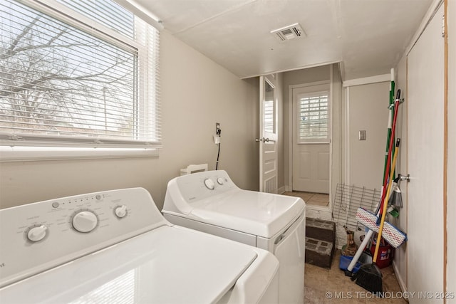 laundry room featuring independent washer and dryer and light colored carpet