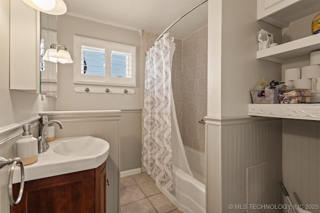 bathroom featuring tile patterned floors, vanity, shower / bath combo with shower curtain, and ornamental molding