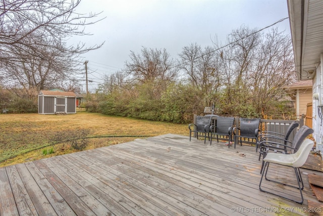 deck featuring a storage shed and a yard