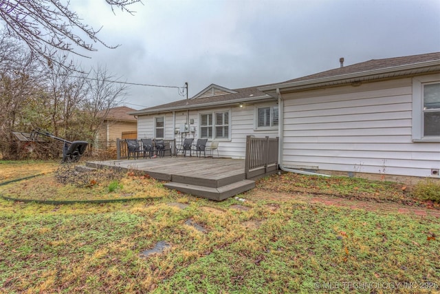 back of house featuring a yard and a deck