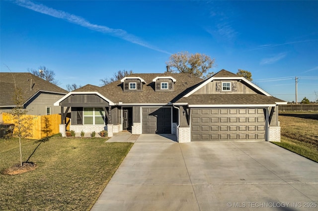 view of front of property featuring a garage and a front lawn