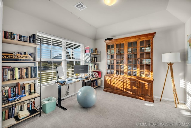 carpeted office featuring vaulted ceiling