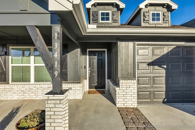 view of exterior entry with a garage