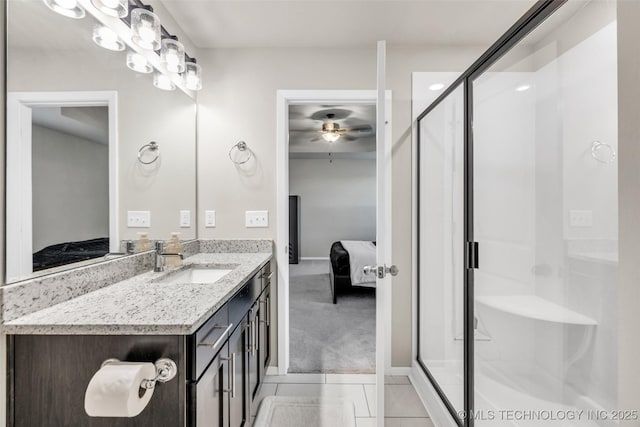 bathroom featuring tile patterned flooring, ceiling fan, an enclosed shower, and vanity