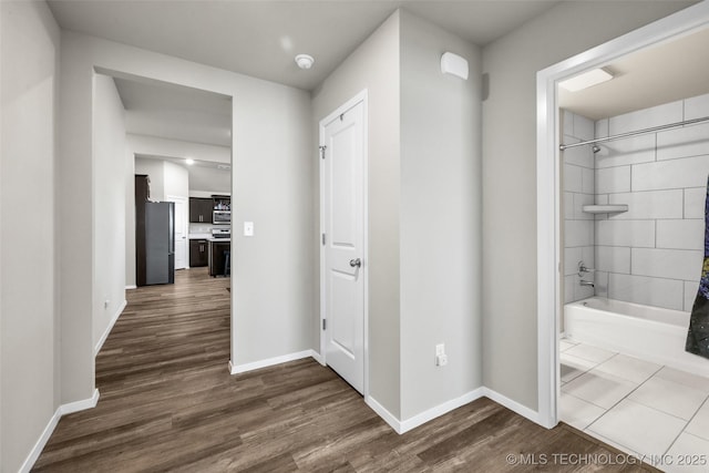 corridor with dark wood-type flooring