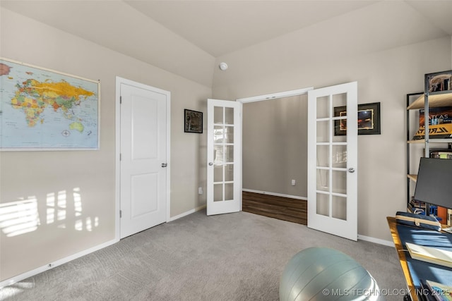 carpeted office with french doors and lofted ceiling