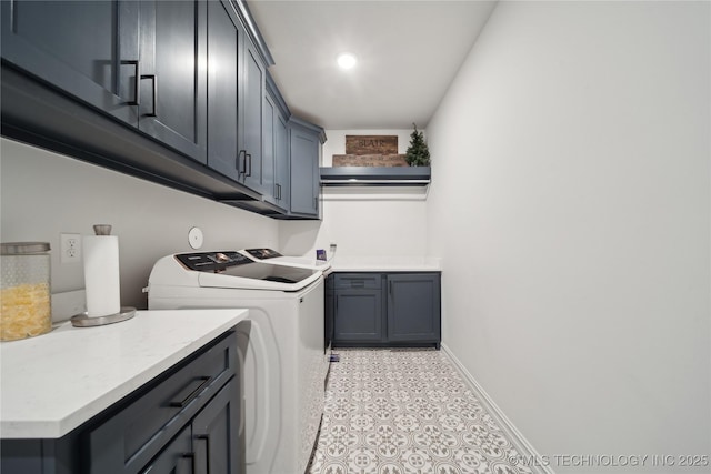 laundry area with cabinets and washing machine and clothes dryer