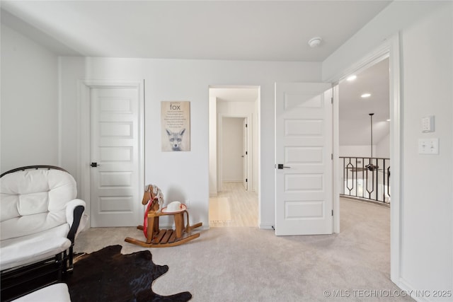 living area with light colored carpet