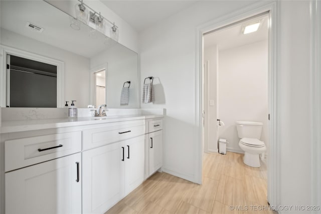 bathroom featuring toilet and vanity