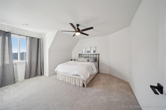 bedroom with ceiling fan, light colored carpet, and lofted ceiling