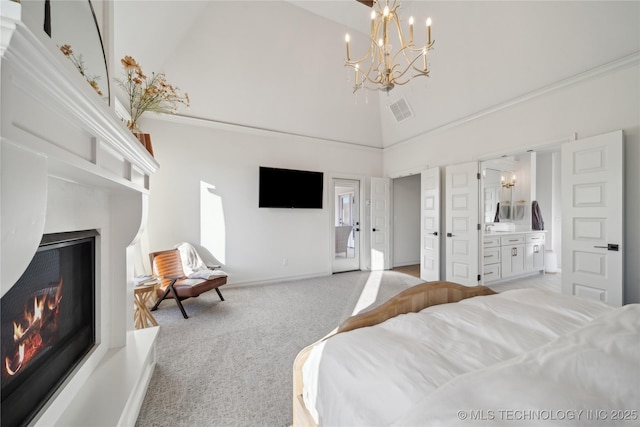 bedroom with an inviting chandelier, ensuite bathroom, light colored carpet, and high vaulted ceiling