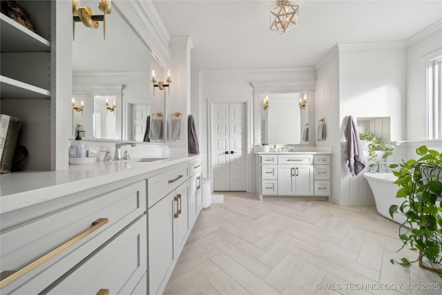 bathroom with ornamental molding, a washtub, vanity, and parquet flooring