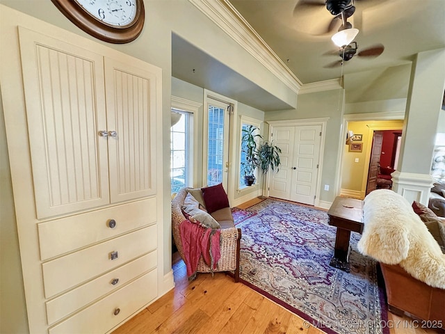 sitting room featuring crown molding, light hardwood / wood-style flooring, and ceiling fan