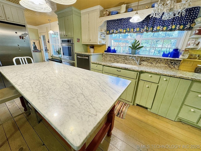 kitchen with pendant lighting, a kitchen island, and sink