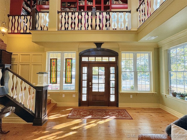 foyer featuring hardwood / wood-style floors and crown molding