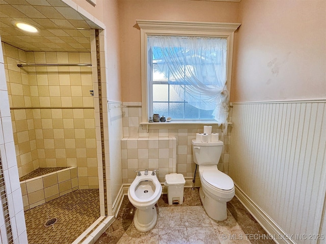 bathroom featuring tiled shower, tile patterned floors, a bidet, and toilet