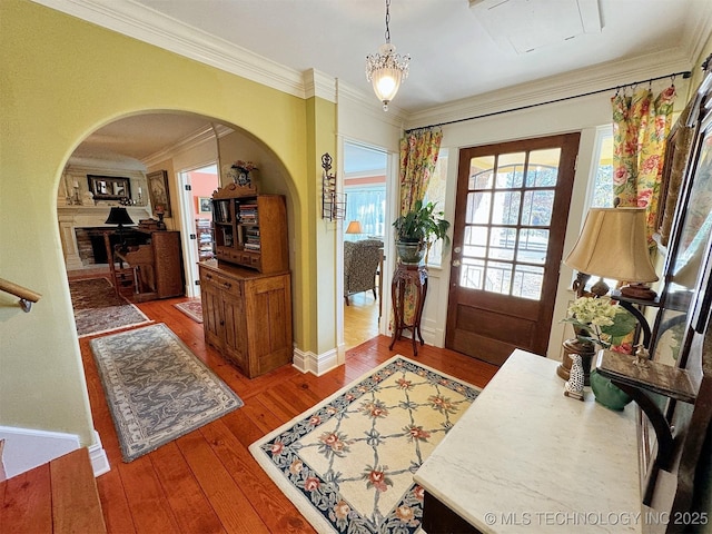 entryway featuring wood-type flooring and ornamental molding