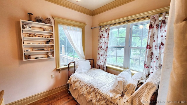 bedroom featuring multiple windows, crown molding, and wood-type flooring