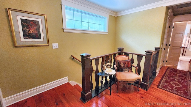 stairway with hardwood / wood-style flooring and crown molding