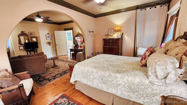 bedroom featuring wood-type flooring, ceiling fan, and ornamental molding