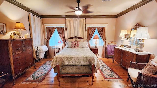 bedroom with wood-type flooring, ceiling fan, and crown molding