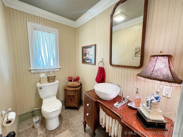 bathroom featuring vanity, toilet, and ornamental molding