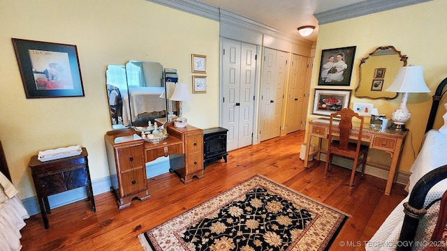 office space featuring wood-type flooring and ornamental molding