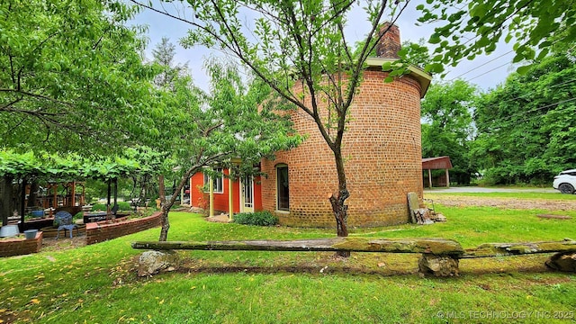 view of side of home featuring a yard