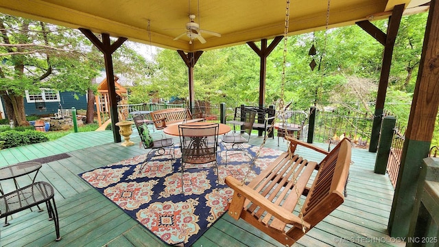 wooden terrace featuring ceiling fan