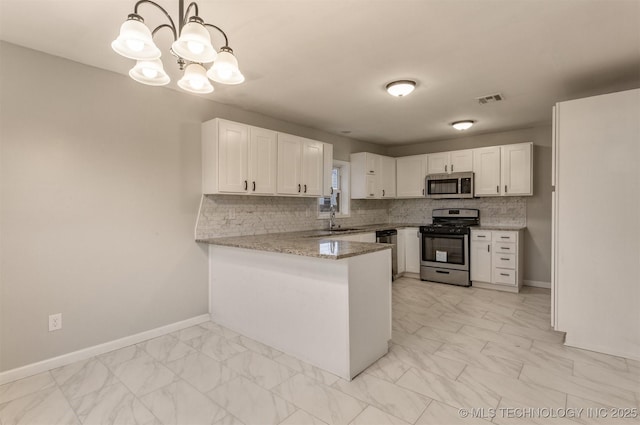 kitchen with sink, hanging light fixtures, kitchen peninsula, white cabinets, and appliances with stainless steel finishes