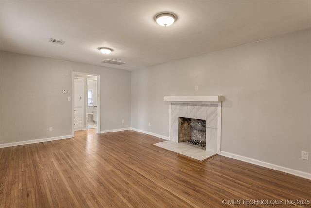 unfurnished living room with wood-type flooring and a premium fireplace