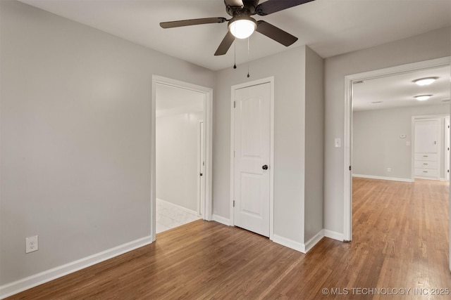 unfurnished bedroom featuring hardwood / wood-style floors and ceiling fan