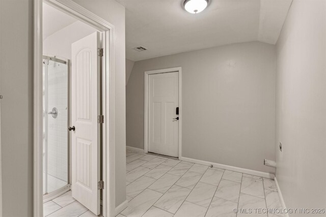 hallway with vaulted ceiling