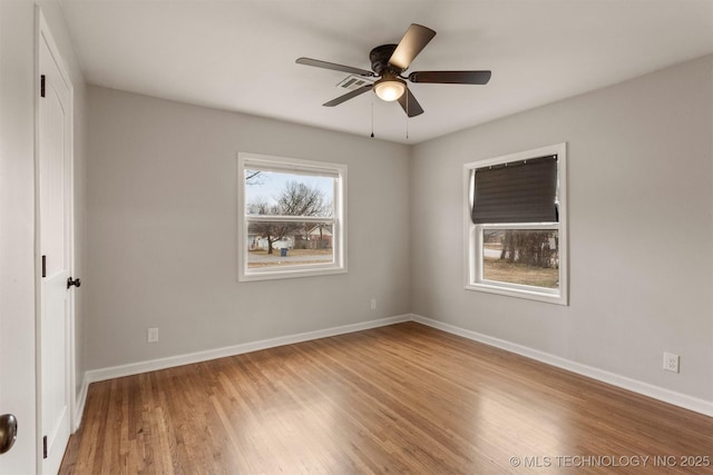 empty room featuring hardwood / wood-style flooring and ceiling fan