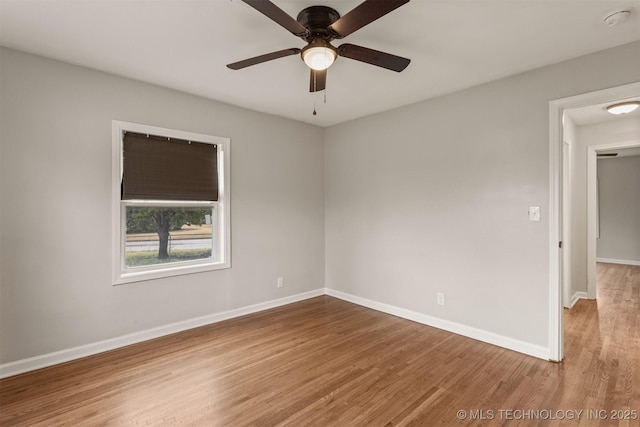 empty room featuring hardwood / wood-style flooring and ceiling fan