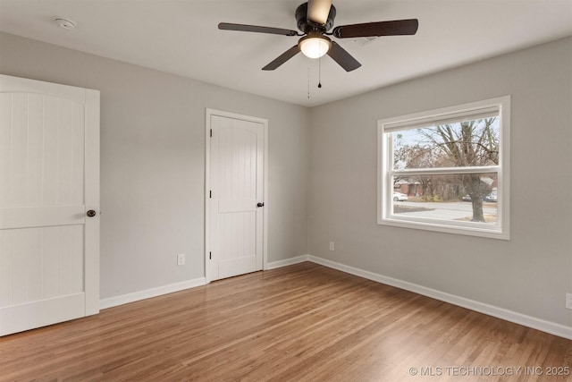 unfurnished bedroom featuring light hardwood / wood-style flooring and ceiling fan