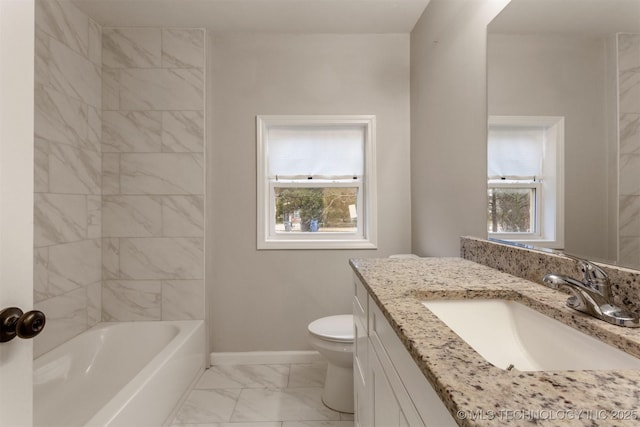 bathroom featuring vanity, a healthy amount of sunlight, and toilet