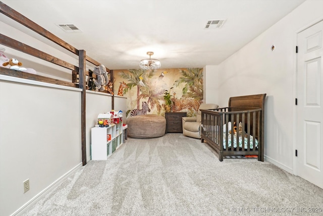 carpeted bedroom featuring an inviting chandelier and a nursery area