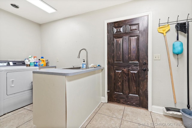 laundry room featuring light tile patterned floors, washer / clothes dryer, and sink