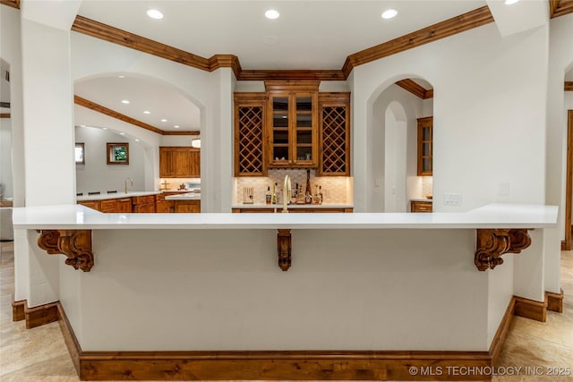 kitchen with kitchen peninsula, a breakfast bar area, and sink