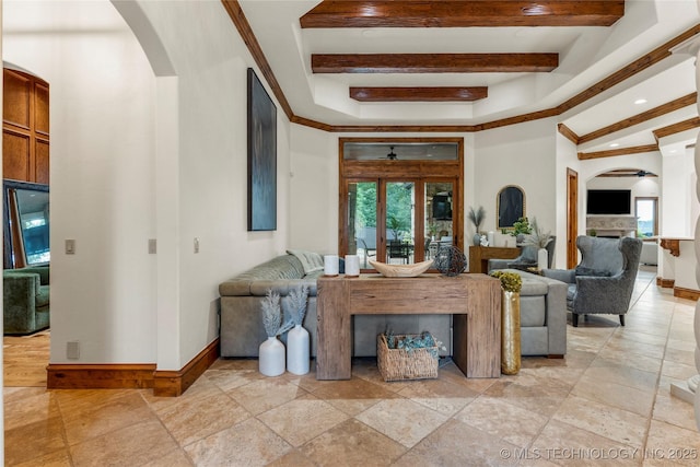 living room featuring ceiling fan, beam ceiling, and ornamental molding