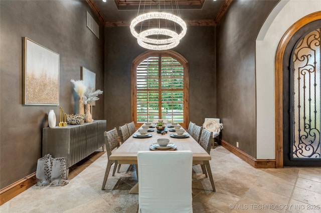 dining area featuring a high ceiling and an inviting chandelier