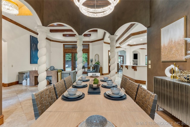 dining area with ornate columns, crown molding, and a chandelier