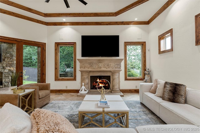 living room with ceiling fan and crown molding