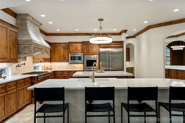 kitchen with a breakfast bar, a spacious island, stainless steel appliances, and tasteful backsplash