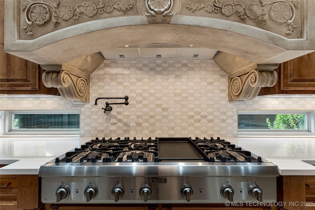 kitchen with stove and tasteful backsplash